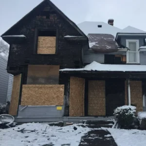 Fire damaged home secured during fire restoration process