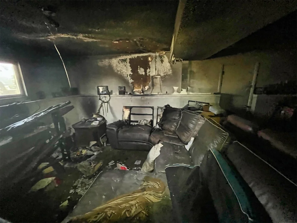 Interior fire damage with smoke and structural impact