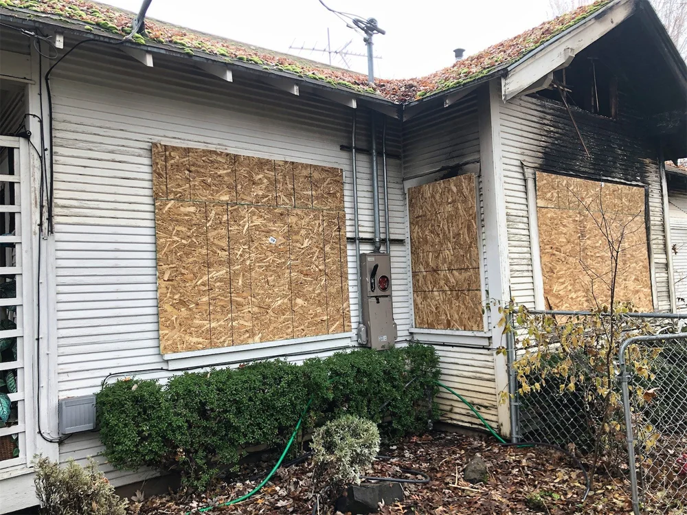 Boarded window securing property after fire or storm damage