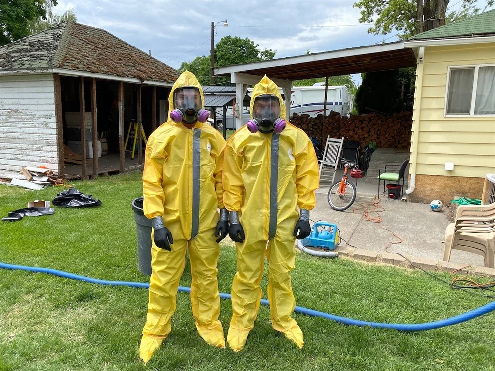 Restoration technicians wearing protective gear on job site