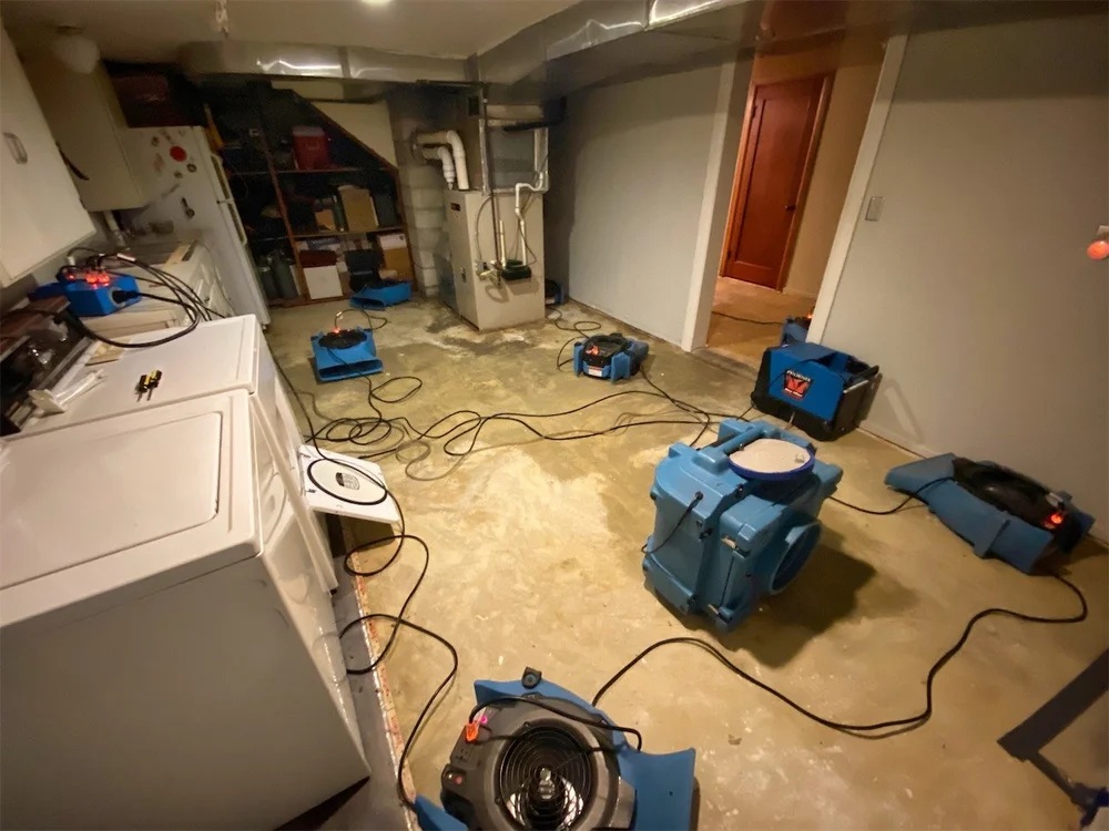 Water damage cleanup with industrial drying equipment inside home
