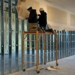 Construction and remodeling crew installing interior framing during property restoration