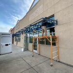 Technician using lift equipment for exterior building restoration work