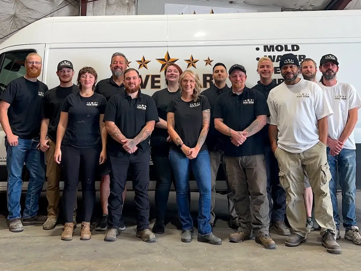 The full Five Star Disaster Services team in front of a company van